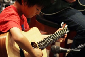 Young child playing the guitar